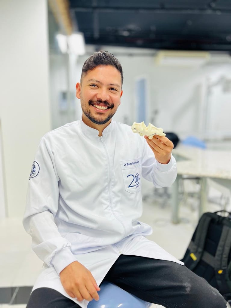 Smiling chef in white coat holding food in a professional kitchen
